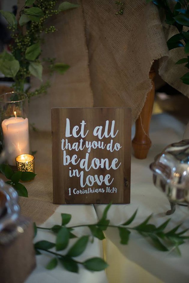 Let al that you do be done in love Bible verse wedding sign at a reception