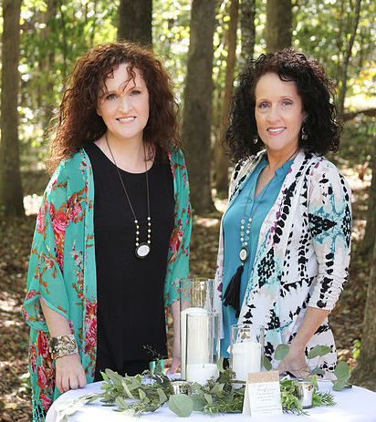 Carrie and Nina from forgethimknot.com setting up a wedding table