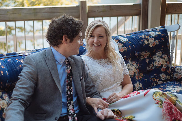  Bride and groom on a floral couch forgethimknot.com