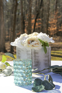 rustic white wood box with white roses and a blue mercury glass candle holder wedding centerpiece