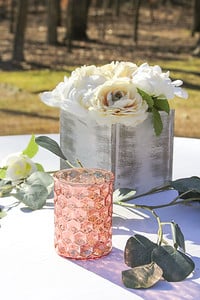 pink mercury glass candle holder with a white wood and roses wedding centerpiece
