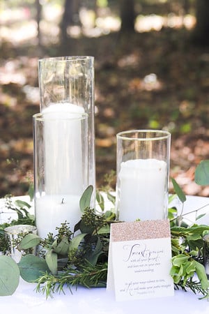 clear vase with pillar candles for wedding reception