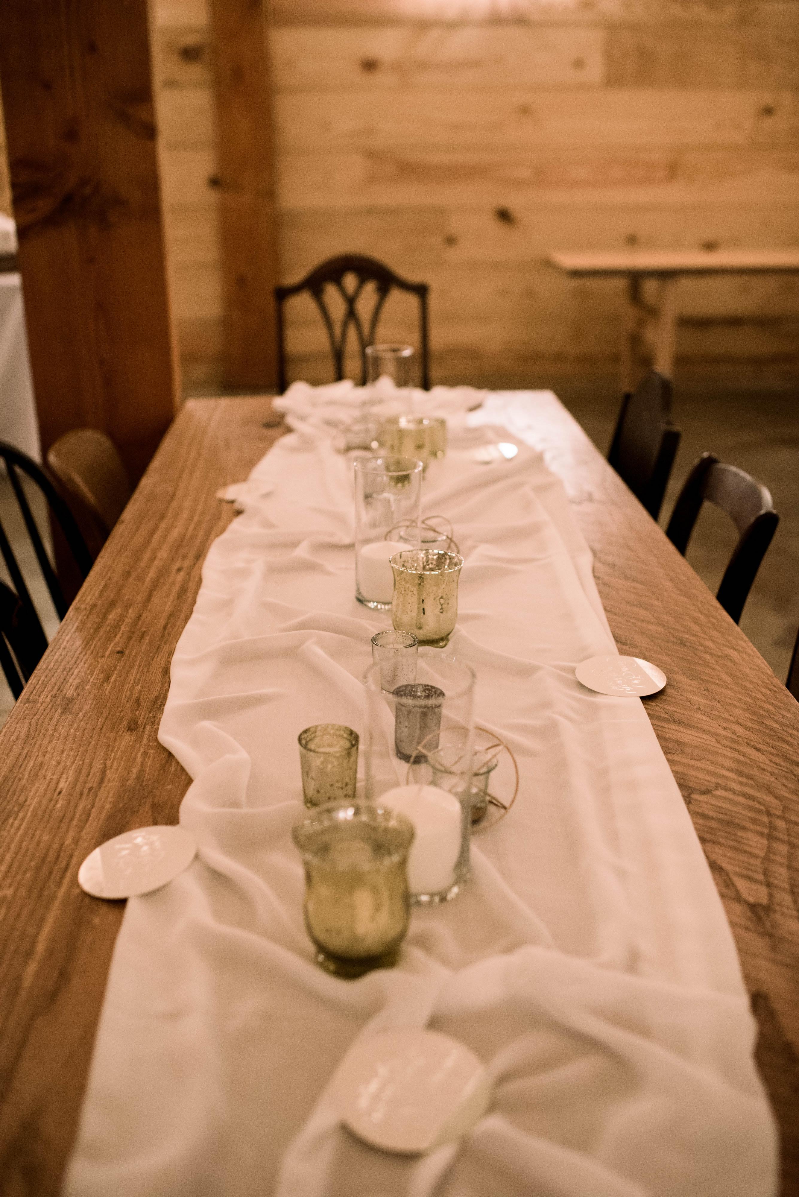 Wedding reception table decor of candles and mercury glass needing seeded eucalyptus #weddings #weddingreception