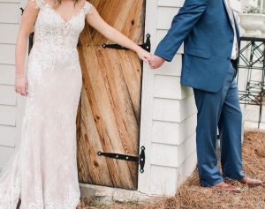 Bride and groom holding hands in prayer