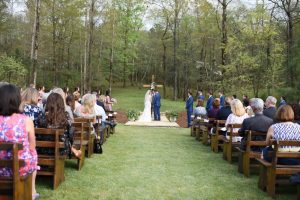 Bride and Groom under a wedding cross