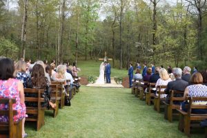 Bride and Groom under a wedding cross