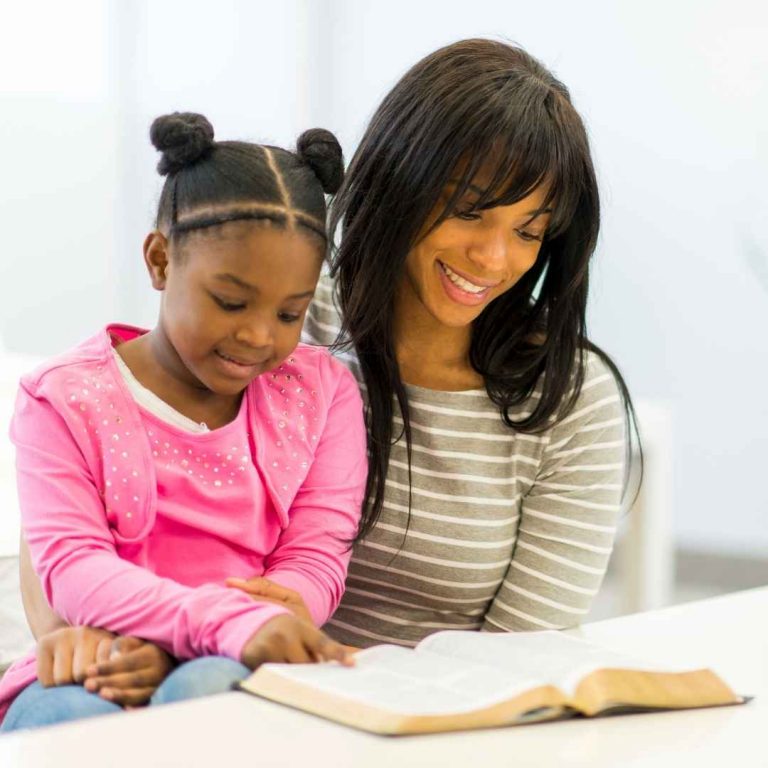 Mom and daughter reading the Bible