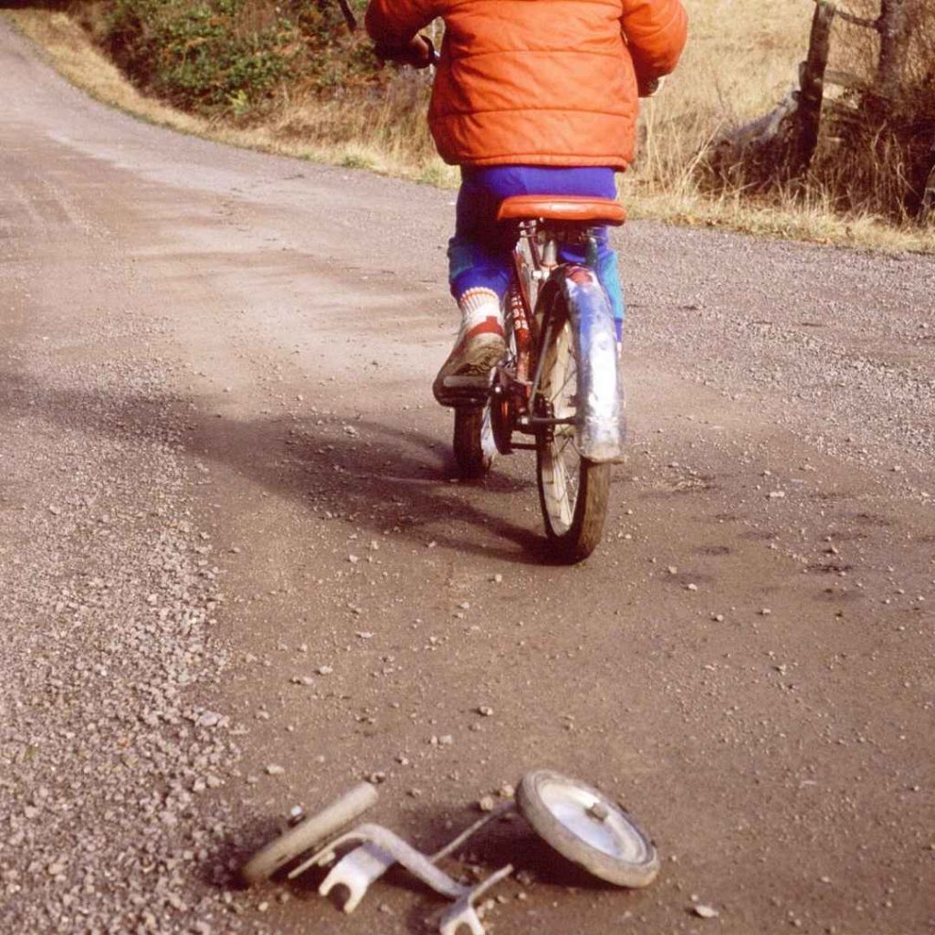 child riding bike ditching training wheels